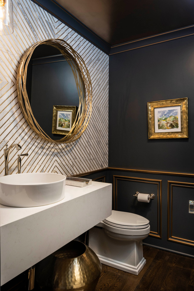 Inspiration for a small traditional powder room in Indianapolis with white cabinets, a one-piece toilet, white tile, marble, blue walls, medium hardwood floors, a vessel sink, engineered quartz benchtops, brown floor, white benchtops, a floating vanity and panelled walls.