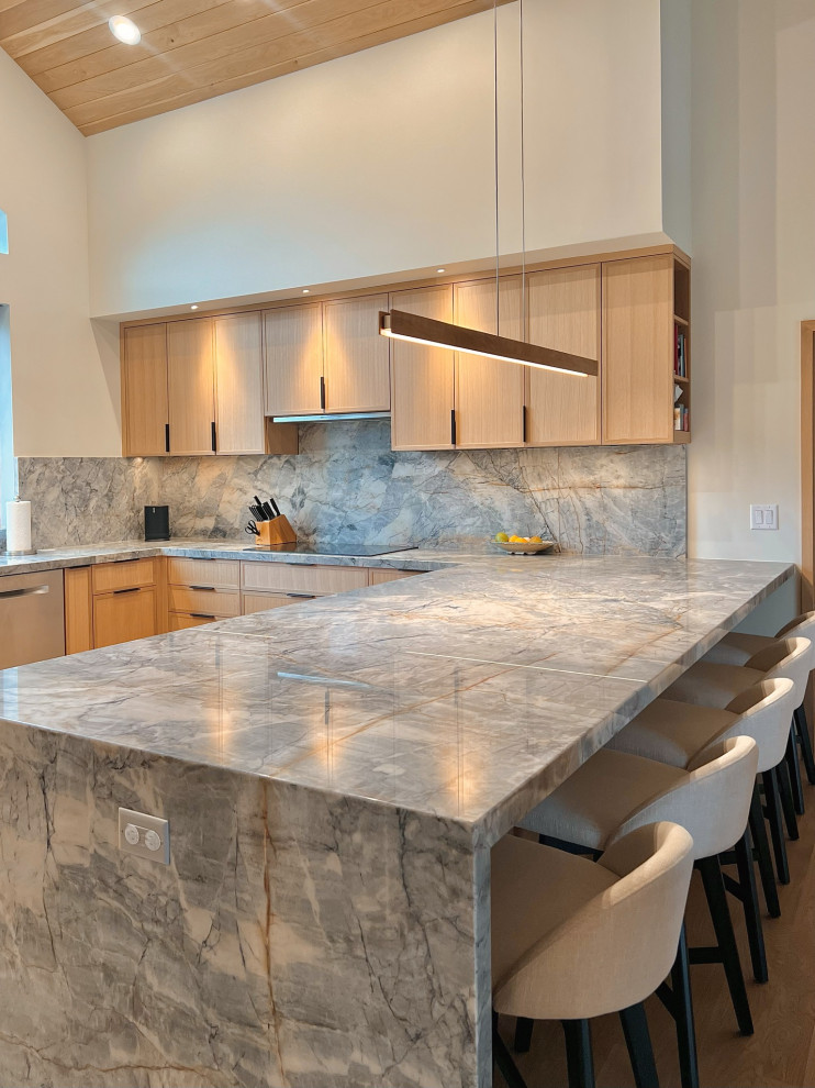 Example of an u-shaped kitchen design in Chicago with light wood cabinets, quartzite countertops, blue backsplash, stone slab backsplash and blue countertops