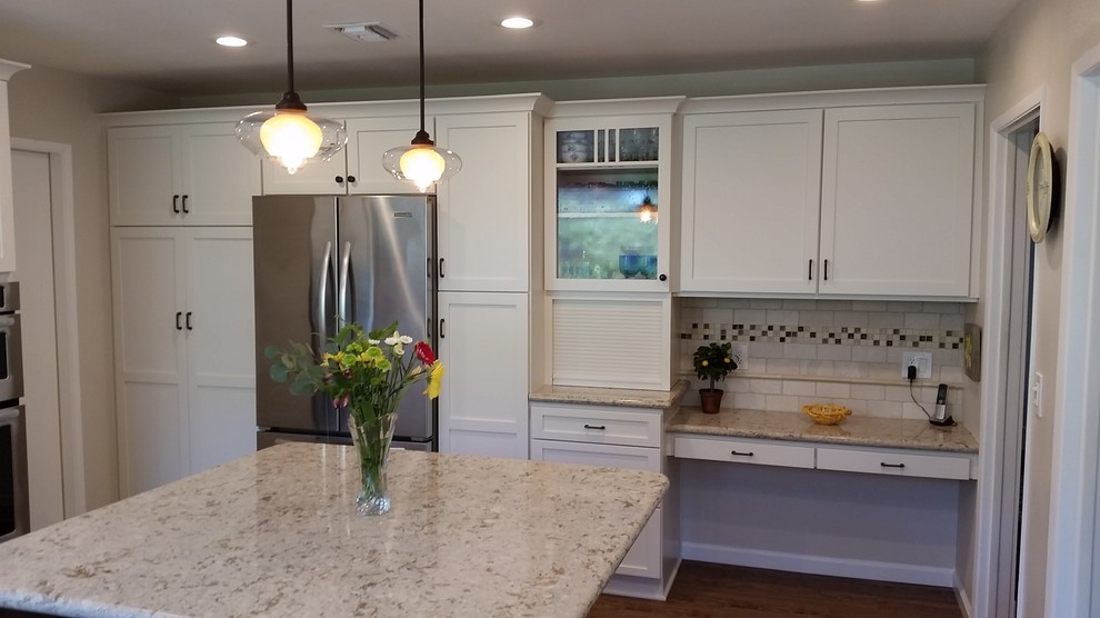 Photo of a mid-sized transitional l-shaped kitchen in Orange County with an undermount sink, shaker cabinets, beige cabinets, multi-coloured splashback, subway tile splashback, stainless steel appliances and with island.