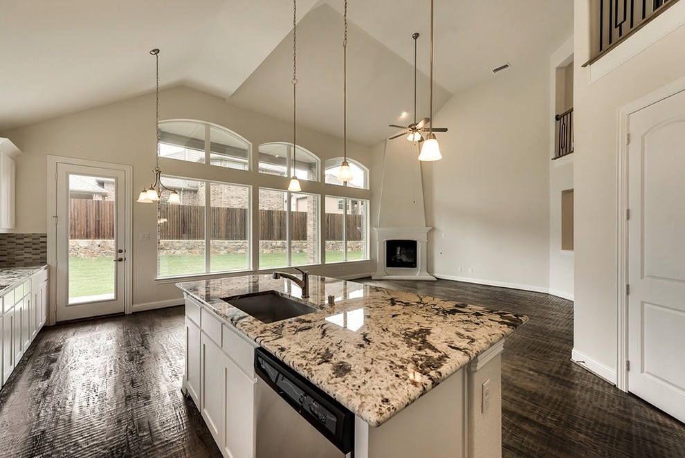 Example of a mid-sized transitional l-shaped dark wood floor and brown floor kitchen design with an undermount sink, shaker cabinets, white cabinets, granite countertops, stainless steel appliances, an island and multicolored countertops