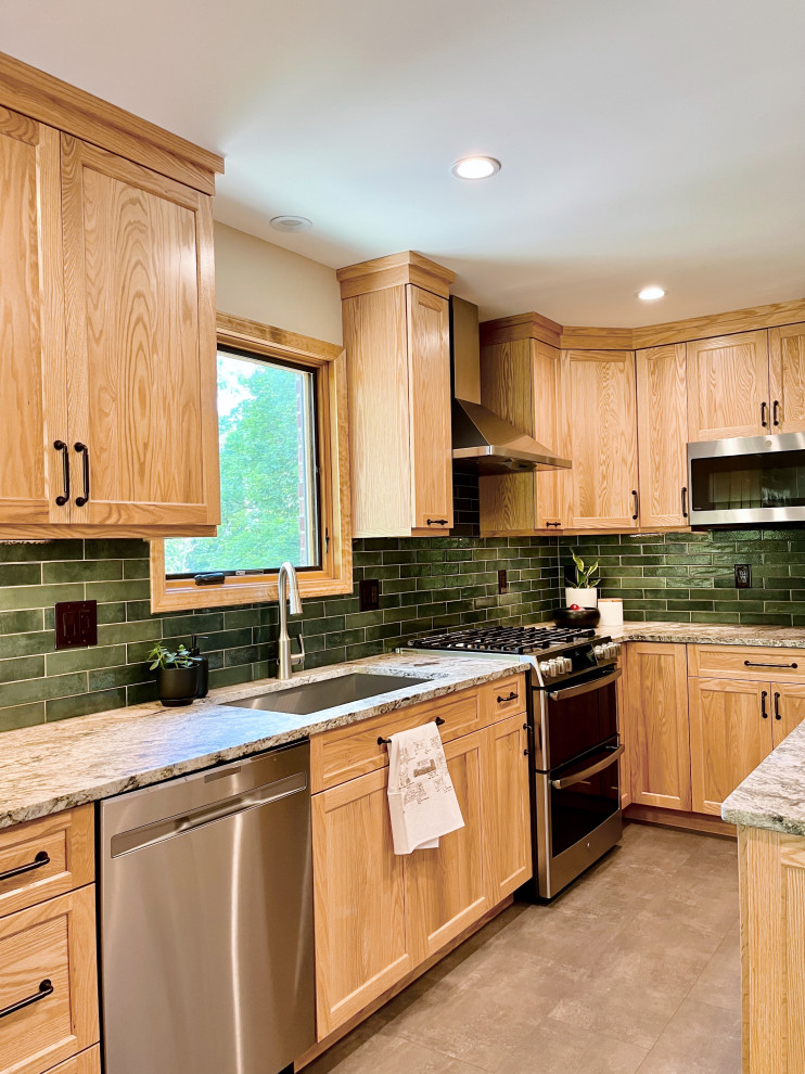 Example of a mid-sized transitional u-shaped vinyl floor and gray floor kitchen pantry design with an undermount sink, shaker cabinets, light wood cabinets, granite countertops, green backsplash, porcelain backsplash, stainless steel appliances, a peninsula and gray countertops