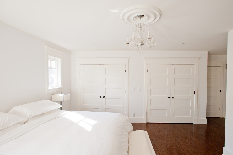 Mid-sized beach style guest bedroom in Toronto with white walls, dark hardwood floors, no fireplace and brown floor.