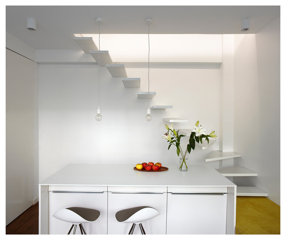 Inspiration for a small contemporary open plan dining in Paris with white walls and no fireplace.