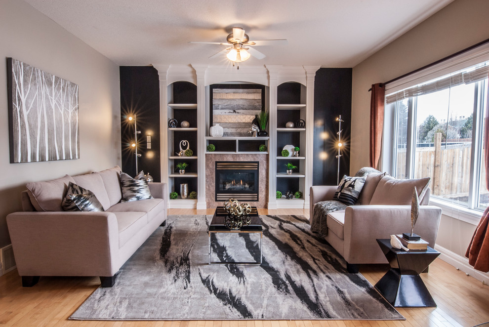 Inspiration for a transitional formal enclosed living room in Edmonton with multi-coloured walls, light hardwood floors, a standard fireplace, a stone fireplace surround, no tv and beige floor.