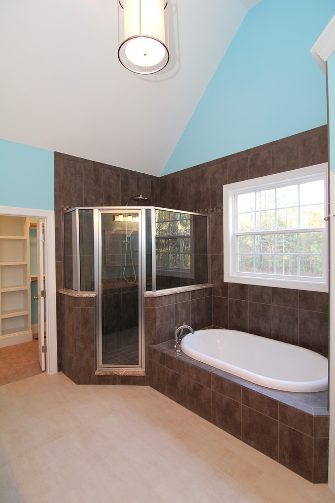 Design ideas for a large transitional master bathroom in Raleigh with an undermount sink, recessed-panel cabinets, dark wood cabinets, granite benchtops, a drop-in tub, a corner shower, a one-piece toilet, brown tile, ceramic tile, blue walls and ceramic floors.