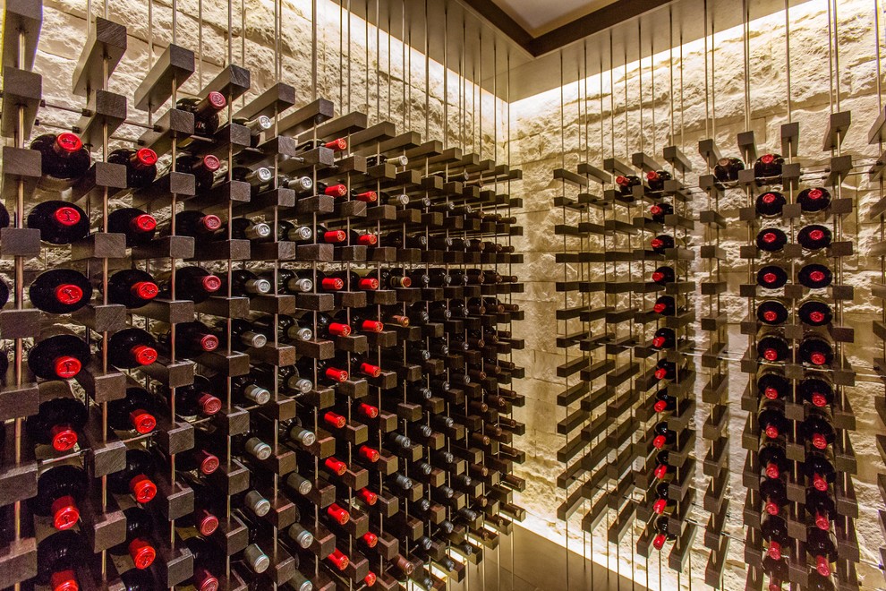 This is an example of a contemporary wine cellar in Boston with travertine floors, display racks and grey floor.