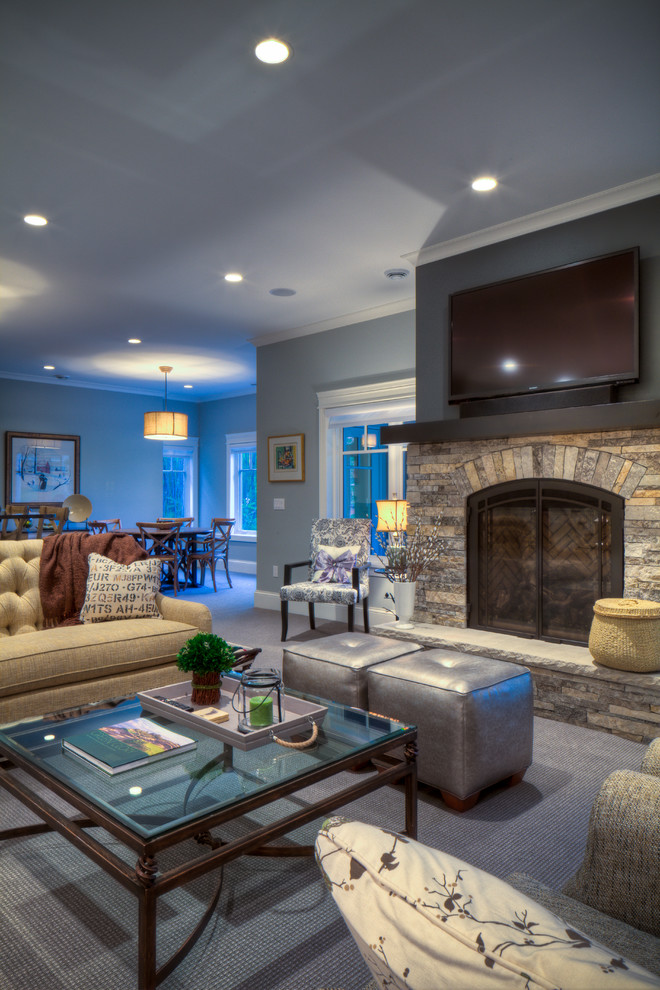 This is an example of a traditional living room in Milwaukee with blue walls and a stone fireplace surround.