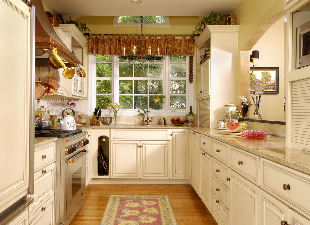 Inspiration for a traditional u-shaped separate kitchen in DC Metro with raised-panel cabinets, beige cabinets and beige splashback.