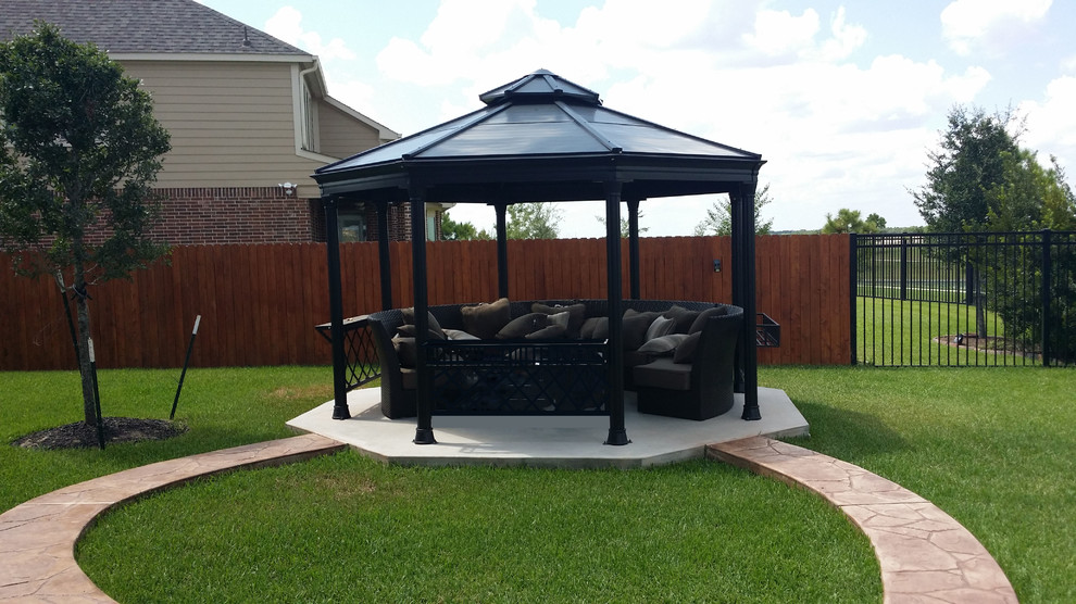 Patio - small backyard stamped concrete patio idea in Houston with a gazebo