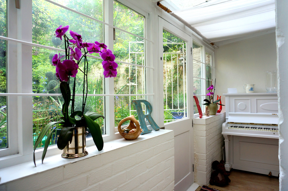 Photo of an eclectic entryway in London with a dutch front door.