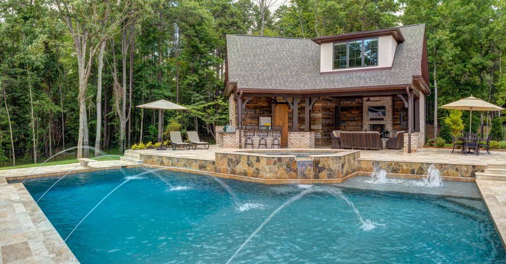 This is an example of a country backyard custom-shaped pool in Charlotte.