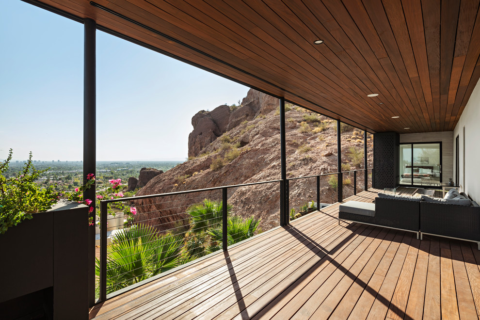 Modern deck in Phoenix with a roof extension.
