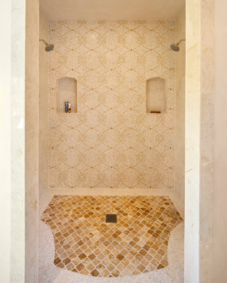 Photo of a mediterranean bathroom in Santa Barbara with an alcove shower, beige tile and beige walls.
