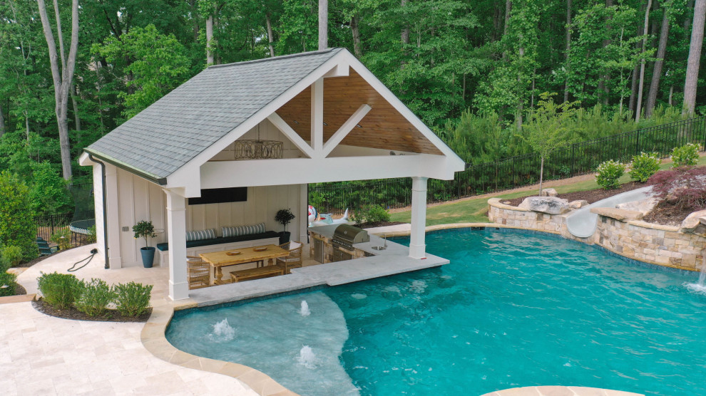 Large traditional backyard pool in Atlanta with a pool house.