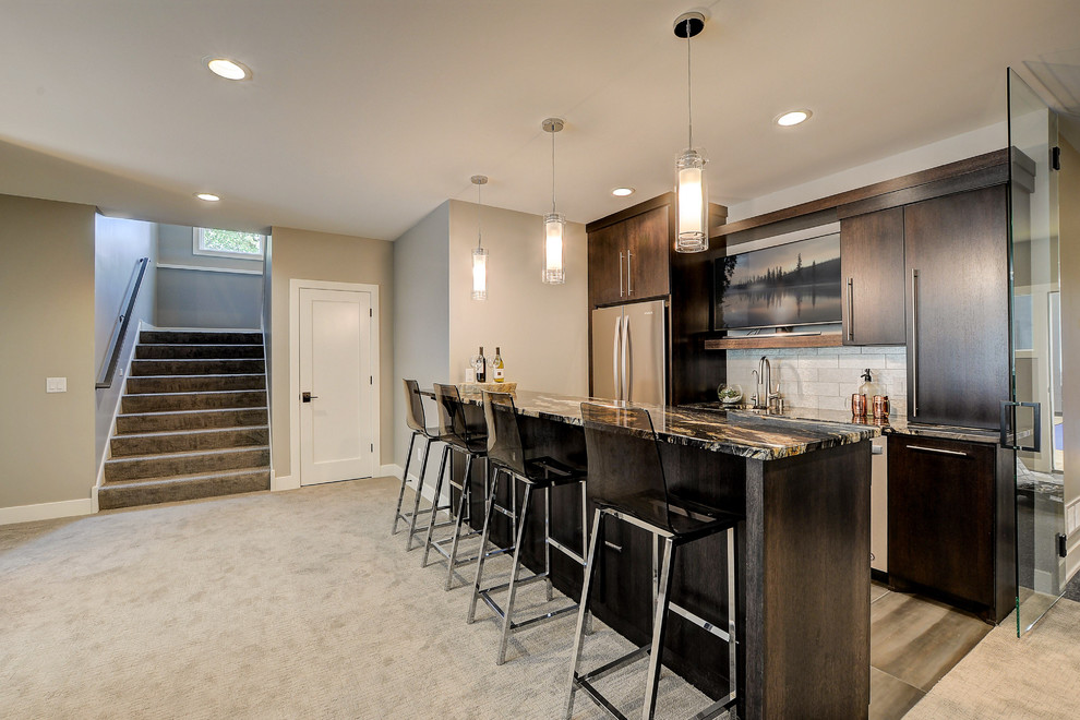 This is an example of a mid-sized contemporary galley seated home bar in Minneapolis with an undermount sink, flat-panel cabinets, dark wood cabinets, granite benchtops, grey splashback, glass tile splashback, porcelain floors, multi-coloured floor and multi-coloured benchtop.