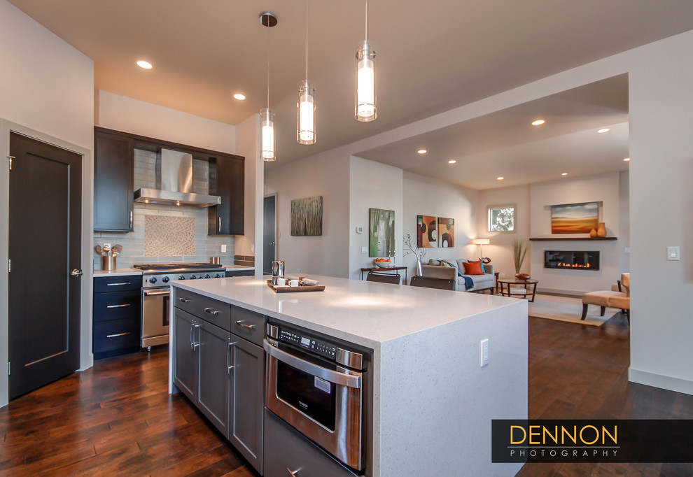 Mid-sized transitional l-shaped dark wood floor and brown floor open concept kitchen photo in Seattle with an undermount sink, shaker cabinets, dark wood cabinets, quartz countertops, brown backsplash, ceramic backsplash, stainless steel appliances, an island and gray countertops
