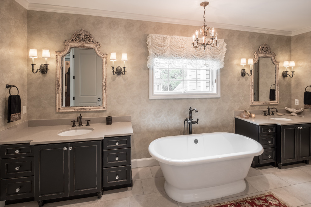 Inspiration for a large master bathroom in Detroit with a double vanity, a built-in vanity, wallpaper, recessed-panel cabinets, black cabinets, a freestanding tub, grey walls, an undermount sink, grey floor and grey benchtops.