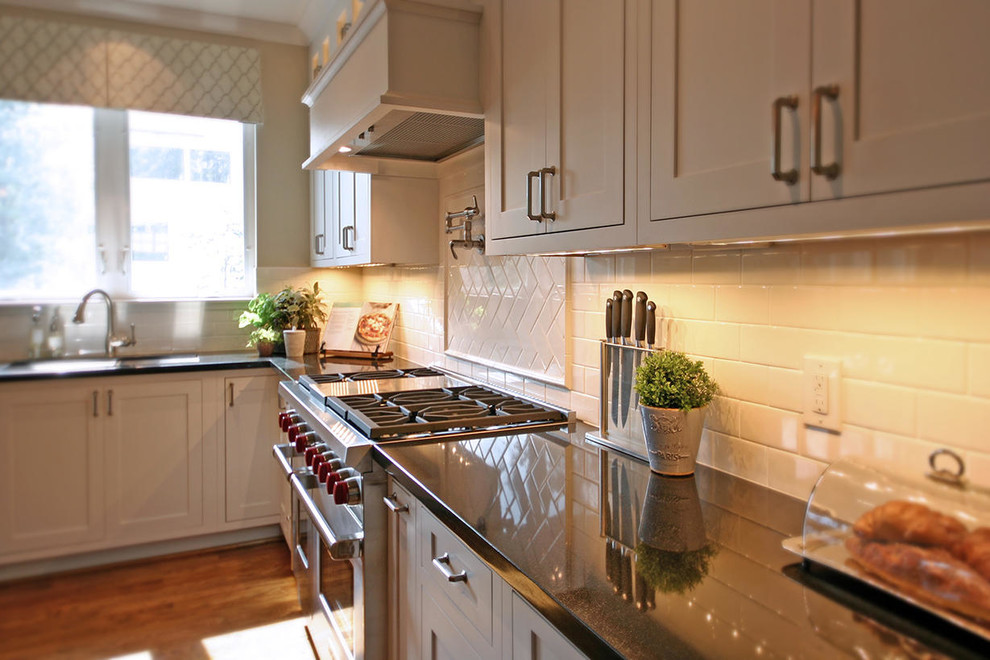 Large transitional medium tone wood floor kitchen photo in Houston with an undermount sink, recessed-panel cabinets and an island