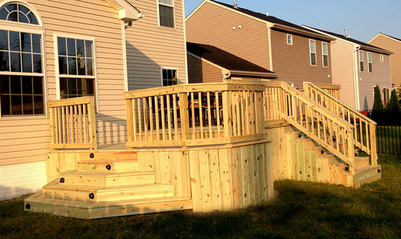 Deck - mid-sized craftsman backyard ground level wood railing deck idea in Cleveland with no cover