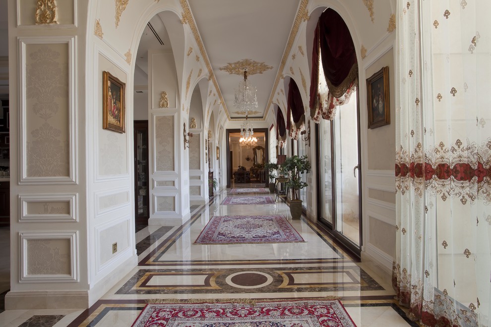 Design ideas for an expansive traditional hallway in Other with marble floors, beige walls and white floor.