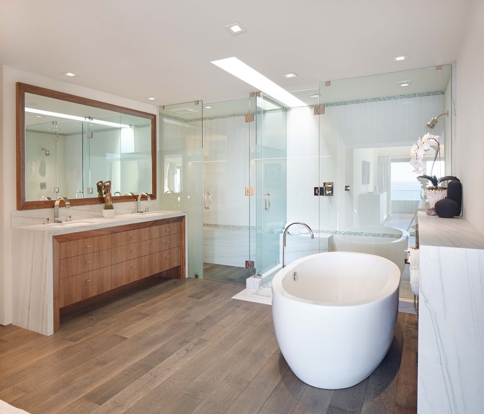 Design ideas for a contemporary master bathroom in Orange County with flat-panel cabinets, medium wood cabinets, a freestanding tub, a corner shower, white tile, white walls, dark hardwood floors, brown floor and a hinged shower door.