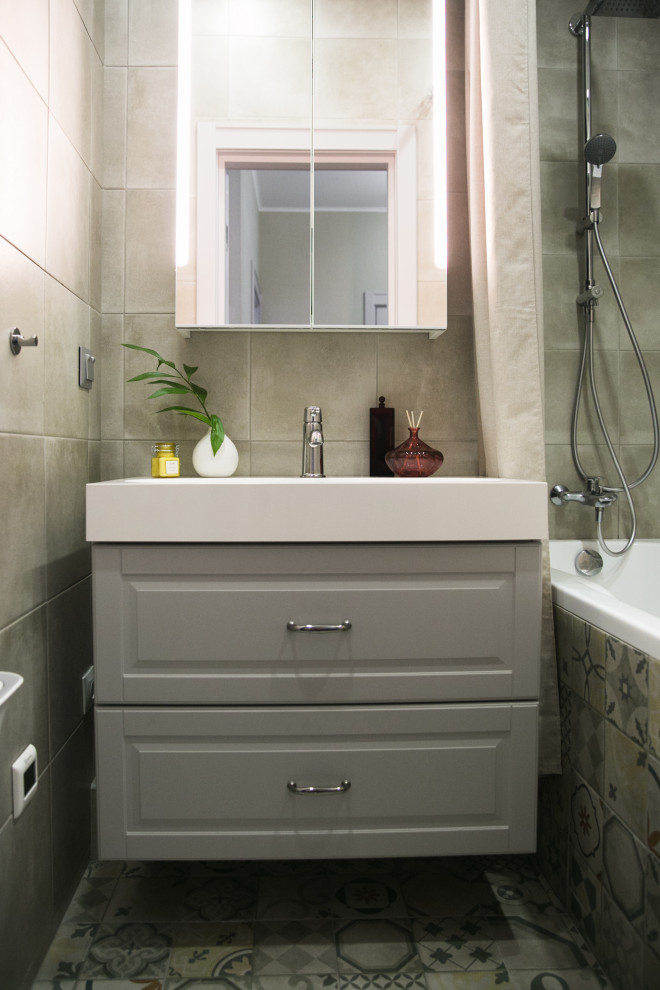 Small scandinavian master bathroom in Saint Petersburg with raised-panel cabinets, grey cabinets, an undermount tub, a shower/bathtub combo, beige tile, porcelain tile, beige walls, porcelain floors, a drop-in sink, solid surface benchtops, beige floor, white benchtops, a single vanity and a floating vanity.
