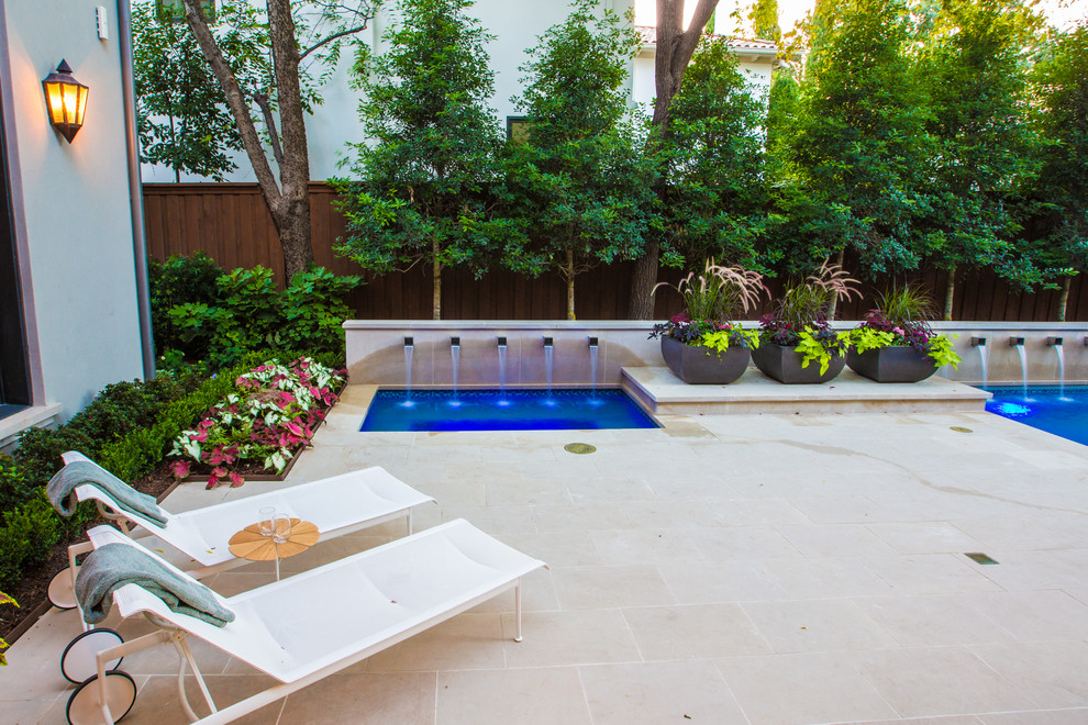 Large transitional backyard stone and rectangular lap pool fountain photo in Dallas