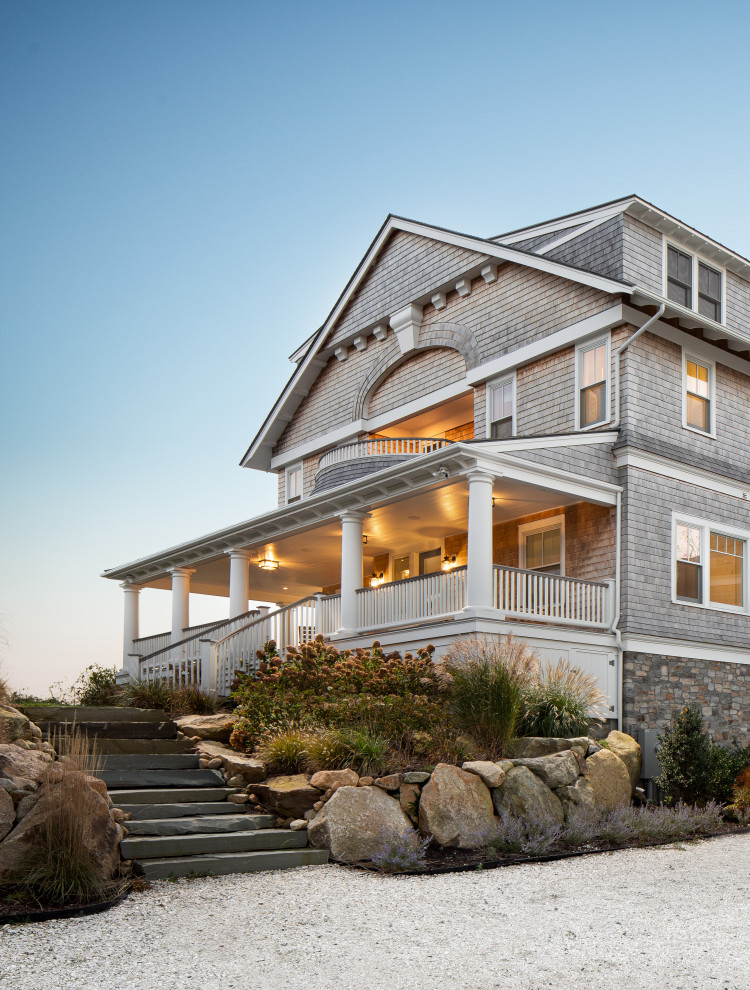 Inspiration for a large beach style grey house exterior in Providence with four or more storeys, wood siding, a gambrel roof, a shingle roof, a brown roof and shingle siding.