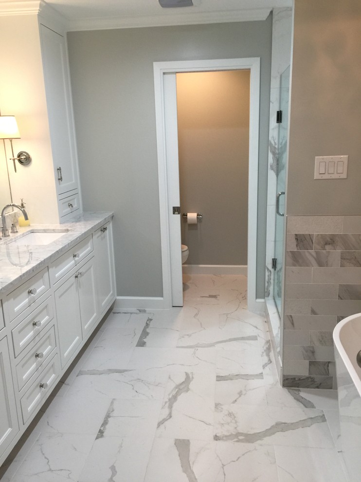 Inspiration for a mid-sized transitional master bathroom in Dallas with recessed-panel cabinets, white cabinets, a freestanding tub, an alcove shower, a two-piece toilet, grey walls, an undermount sink, quartzite benchtops, yellow floor and a hinged shower door.