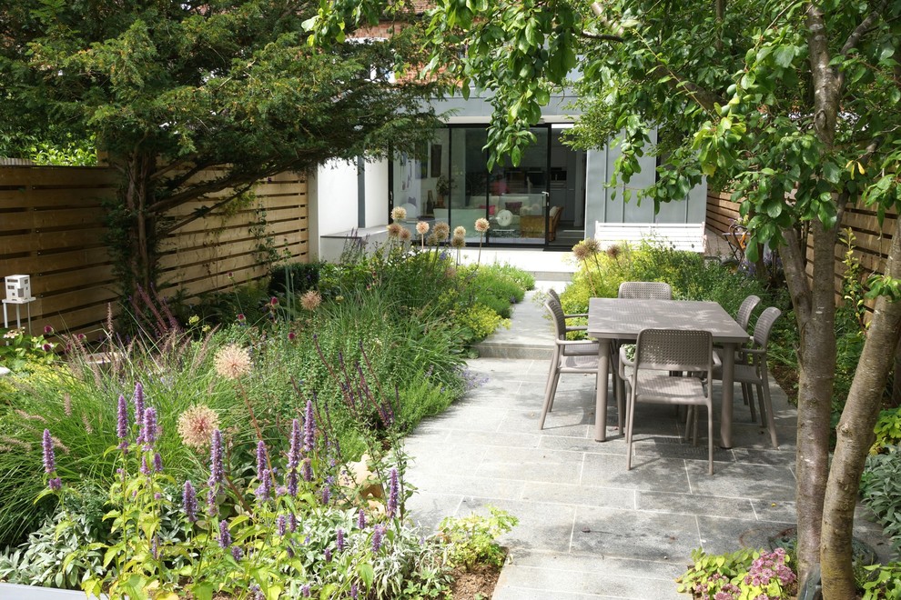 This is an example of a contemporary backyard patio in Oxfordshire with no cover.