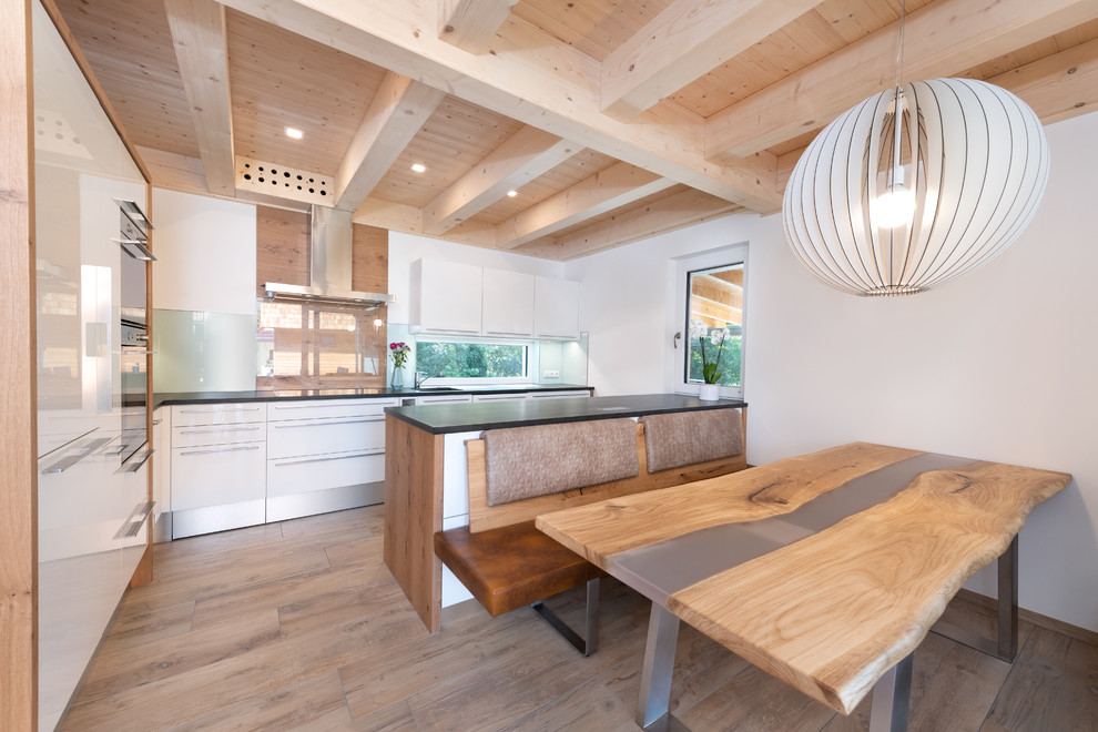 This is an example of a large contemporary eat-in kitchen in Nuremberg with light hardwood floors and beige floor.