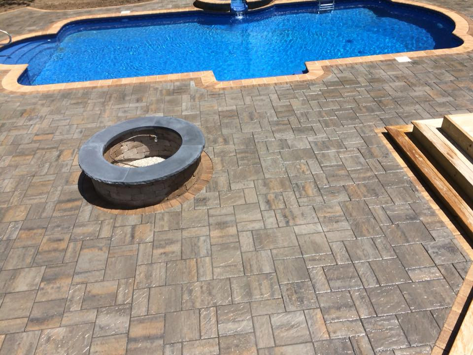 Inspiration for a large transitional backyard concrete paver and custom-shaped hot tub remodel