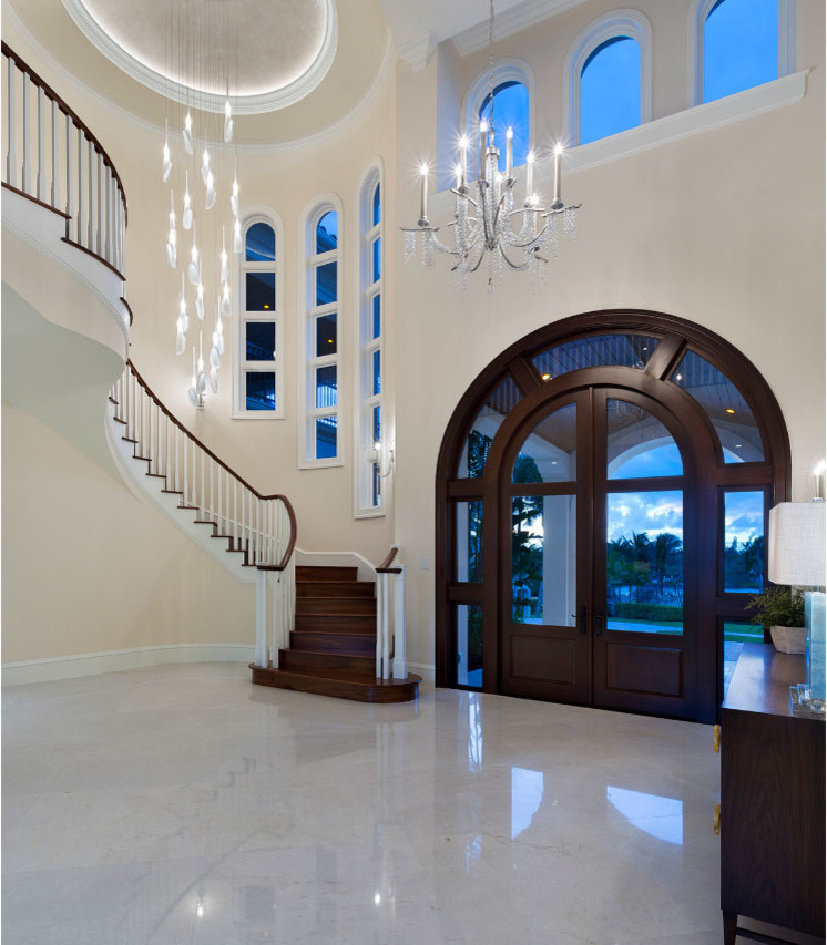 Photo of a mid-sized transitional foyer in Miami with beige walls, marble floors, a double front door, a dark wood front door and multi-coloured floor.