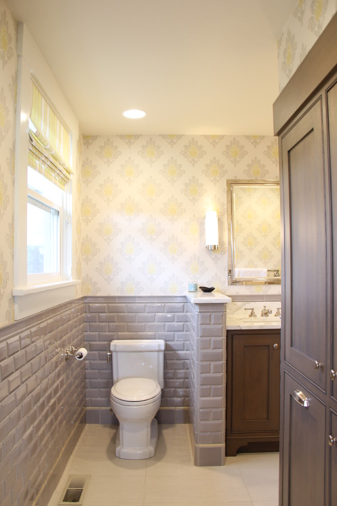 Photo of a mid-sized country master bathroom in Seattle with an undermount sink, recessed-panel cabinets, dark wood cabinets, marble benchtops, a corner shower, a two-piece toilet, gray tile, ceramic tile, white walls and porcelain floors.