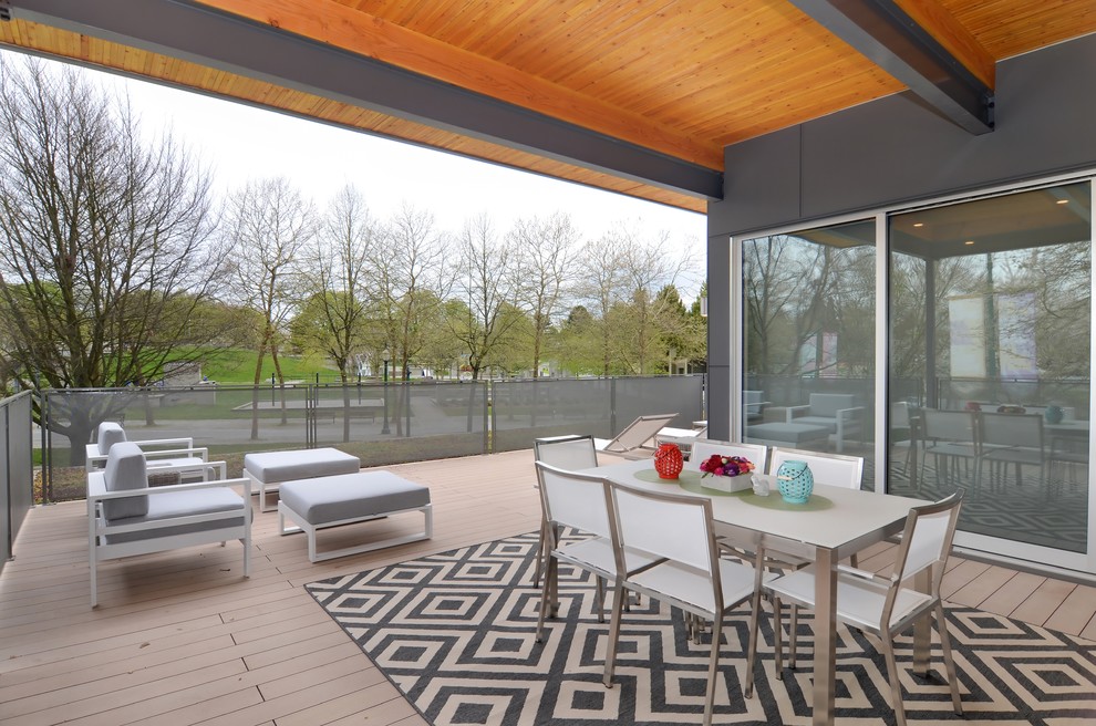 Inspiration for an expansive scandinavian deck in Vancouver with a roof extension.
