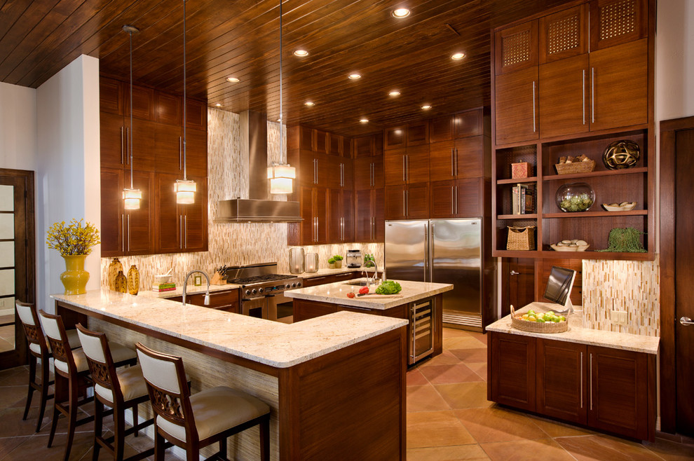 Design ideas for a contemporary u-shaped kitchen in Austin with stainless steel appliances and dark wood cabinets.
