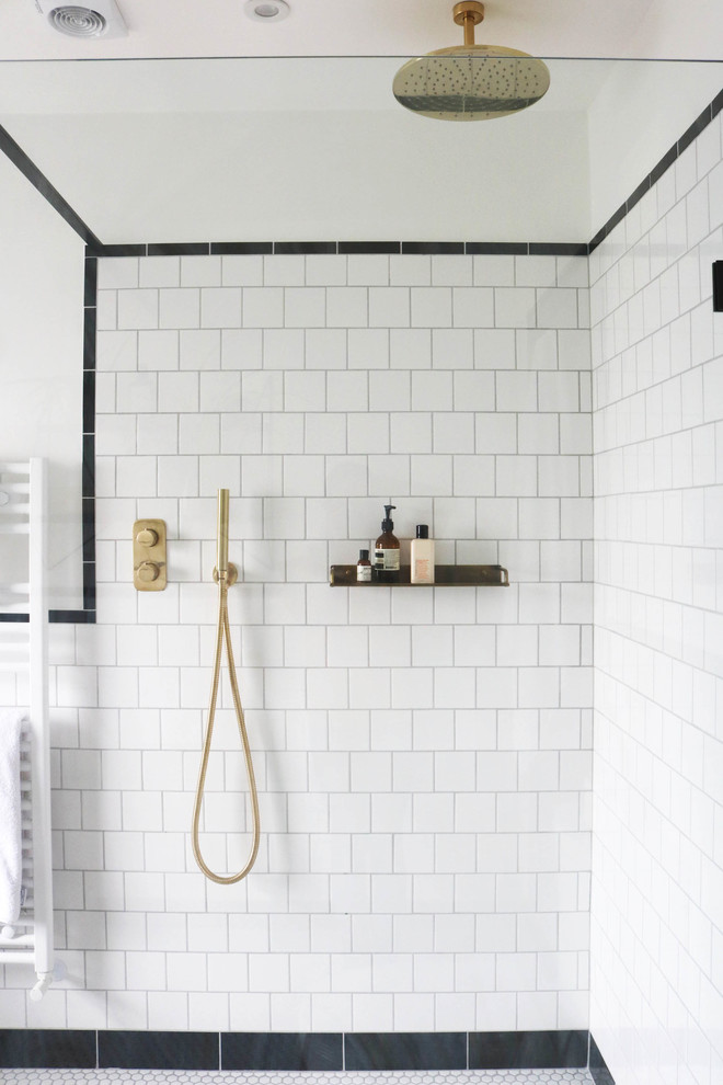 Inspiration for a large midcentury kids wet room bathroom in London with furniture-like cabinets, medium wood cabinets, a freestanding tub, a one-piece toilet, white tile, ceramic tile, white walls, ceramic floors, a console sink, white floor and an open shower.