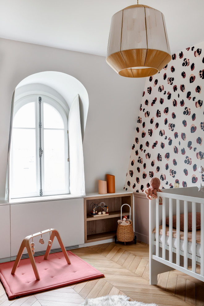 Photo of a contemporary nursery in Paris with a feature wall.