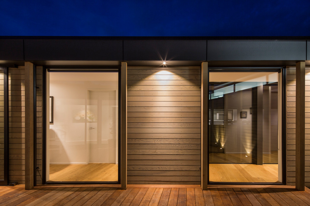 Inspiration for a contemporary one-storey exterior in Christchurch with wood siding.