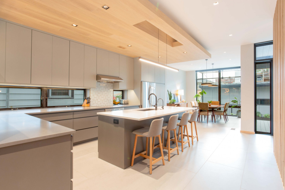 Minimalist Modern Kitchen With Wood Ceiling Detail & Oversized Island