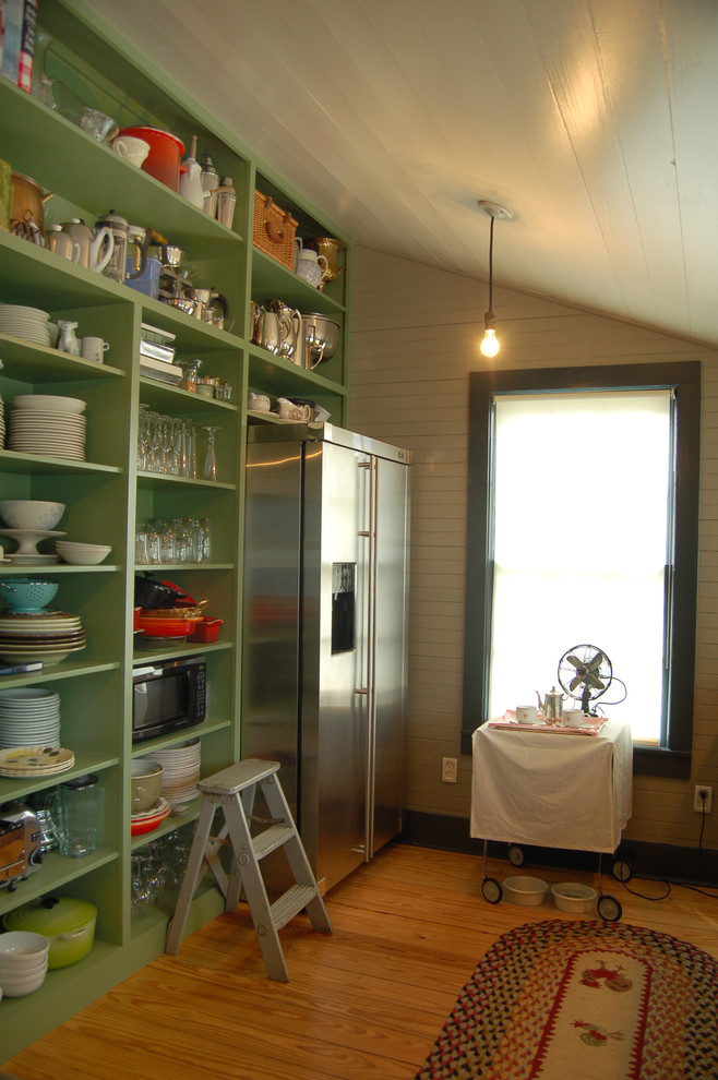 Design ideas for a country separate kitchen in Austin with stainless steel appliances, open cabinets and green cabinets.