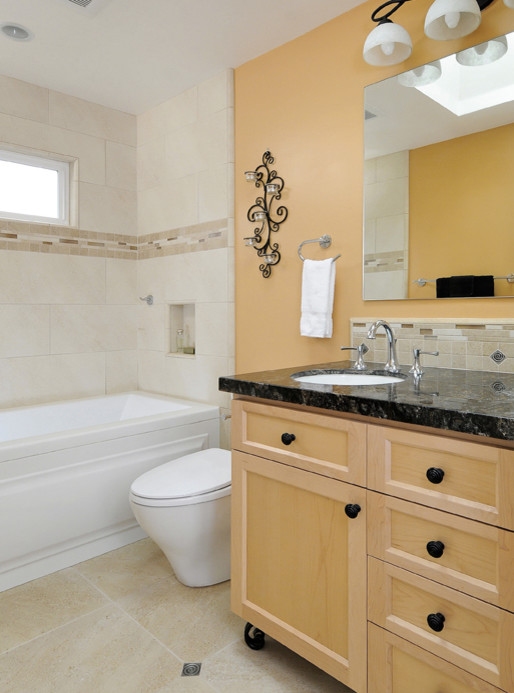 Inspiration for a small transitional 3/4 bathroom in San Francisco with shaker cabinets, light wood cabinets, an alcove tub, a shower/bathtub combo, a two-piece toilet, beige tile, porcelain tile, orange walls, porcelain floors, an undermount sink and granite benchtops.