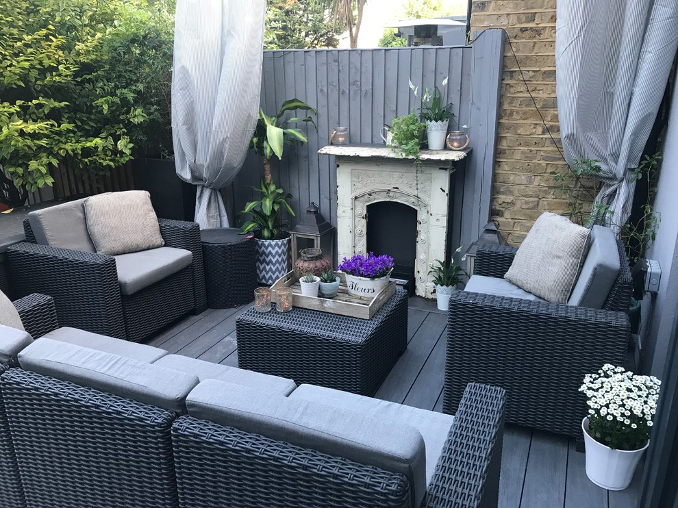 Photo of a small traditional backyard patio in London with decking.