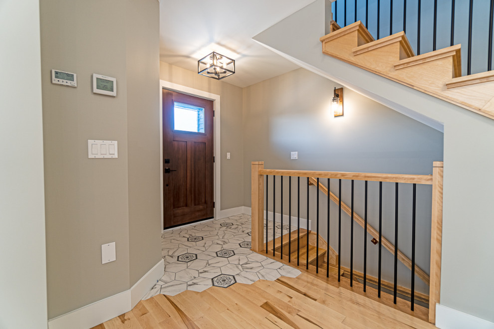 Small transitional ceramic tile and gray floor front door photo with a brown front door