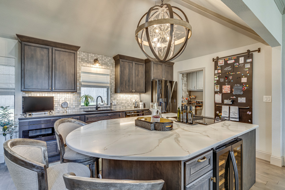 Design ideas for a transitional kitchen in Dallas with brown cabinets, quartzite benchtops, glass tile splashback, with island, white benchtop, an undermount sink, vinyl floors, brown splashback, brown floor and vaulted.