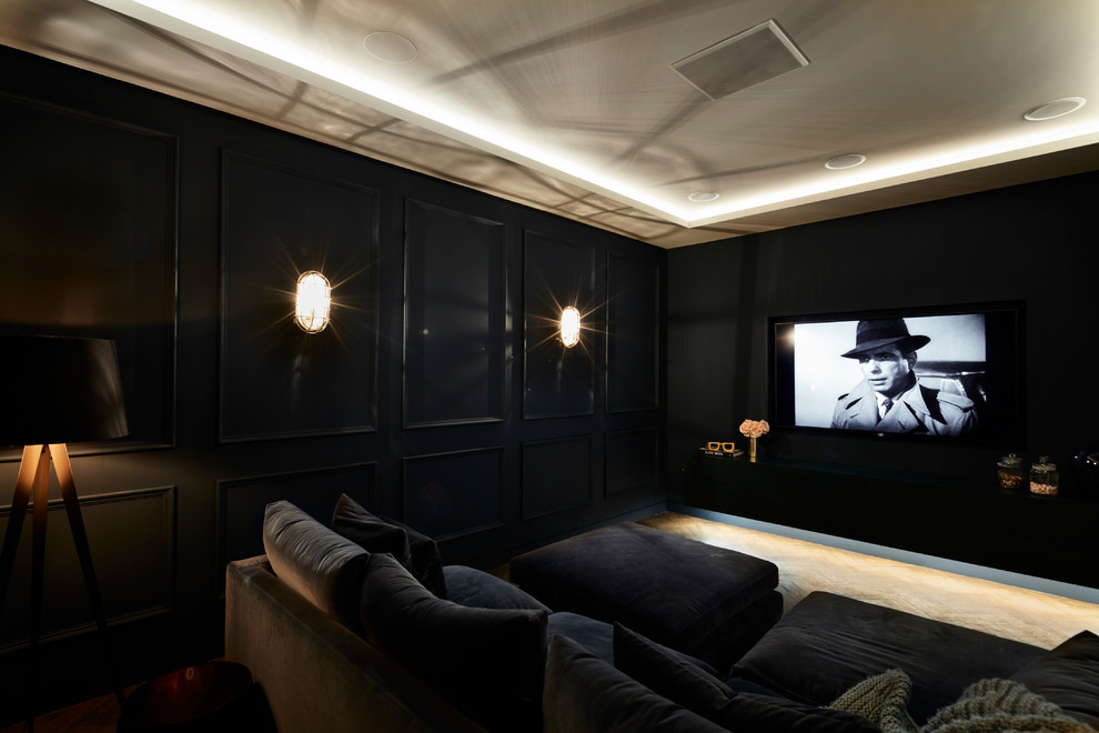 Design ideas for an industrial home theatre in London with a wall-mounted tv.