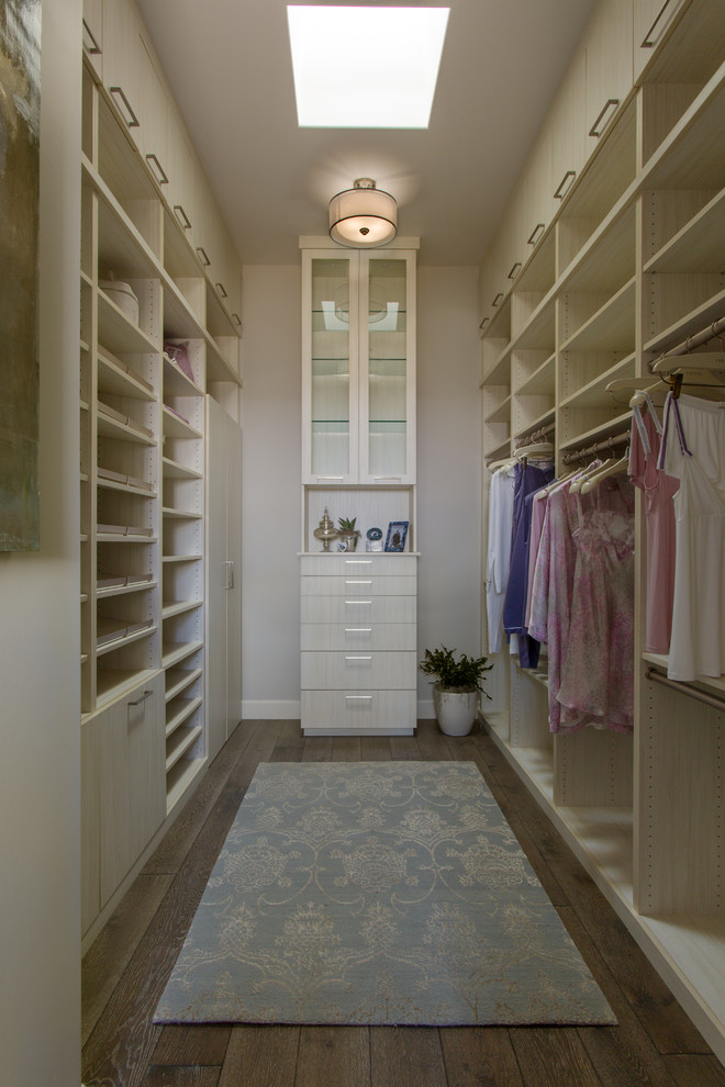 Mid-sized transitional women's walk-in wardrobe in Orange County with flat-panel cabinets, light wood cabinets, dark hardwood floors and brown floor.