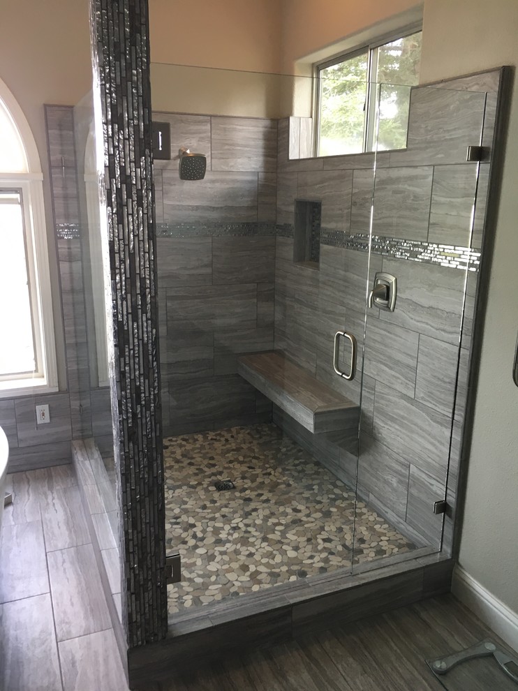 Freestanding bathtub - modern master ceramic tile and gray floor freestanding bathtub idea with flat-panel cabinets, dark wood cabinets, a drop-in sink, quartzite countertops, a hinged shower door and white countertops