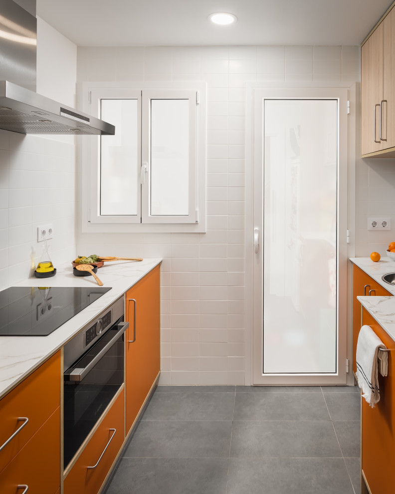 This is an example of a small retro kitchen in Barcelona with a built-in sink, medium wood cabinets, ceramic flooring, grey floors and white worktops.