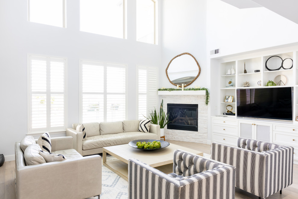 Inspiration for a large classic open plan living room in Other with white walls, light hardwood flooring, a corner fireplace, a stacked stone fireplace surround and a built-in media unit.
